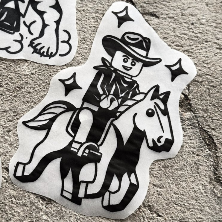 lego cowboy — blackwork flash tattoo by Nick Kozlov